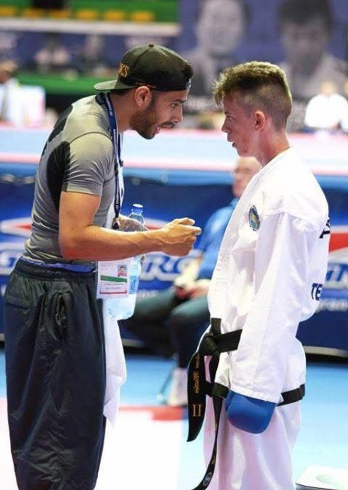 Instructor coaching a black belt competitor